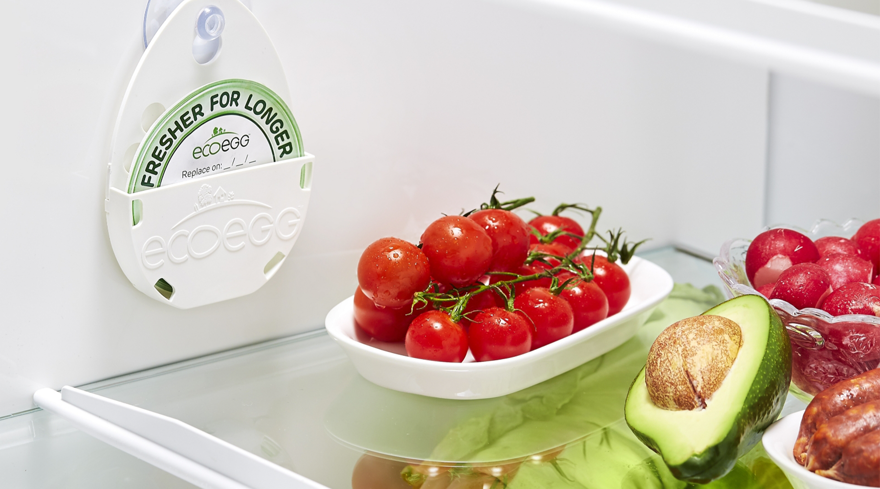 Ecoegg Fresher For Longer disc in a fridge filled with fruit and veg