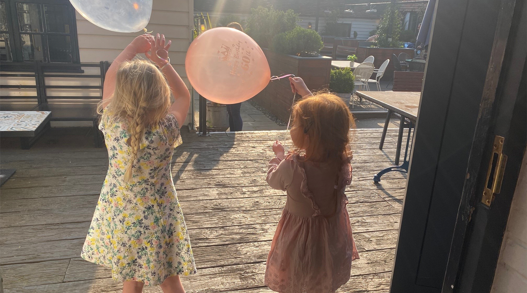 Two young girls with balloons