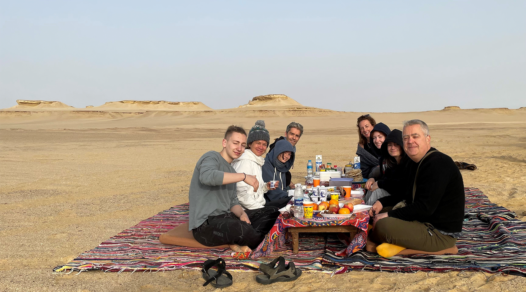 A group of people having a picnic in the desert