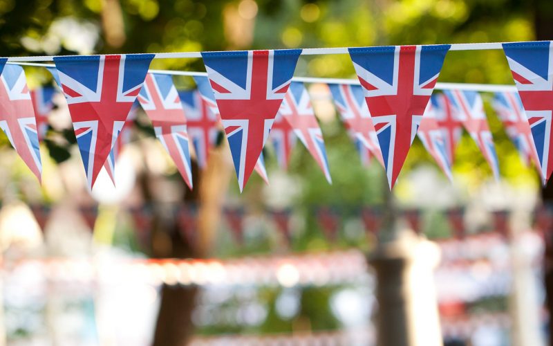 festive garlands of flags with the image of the English flag adorning a festive fairway park